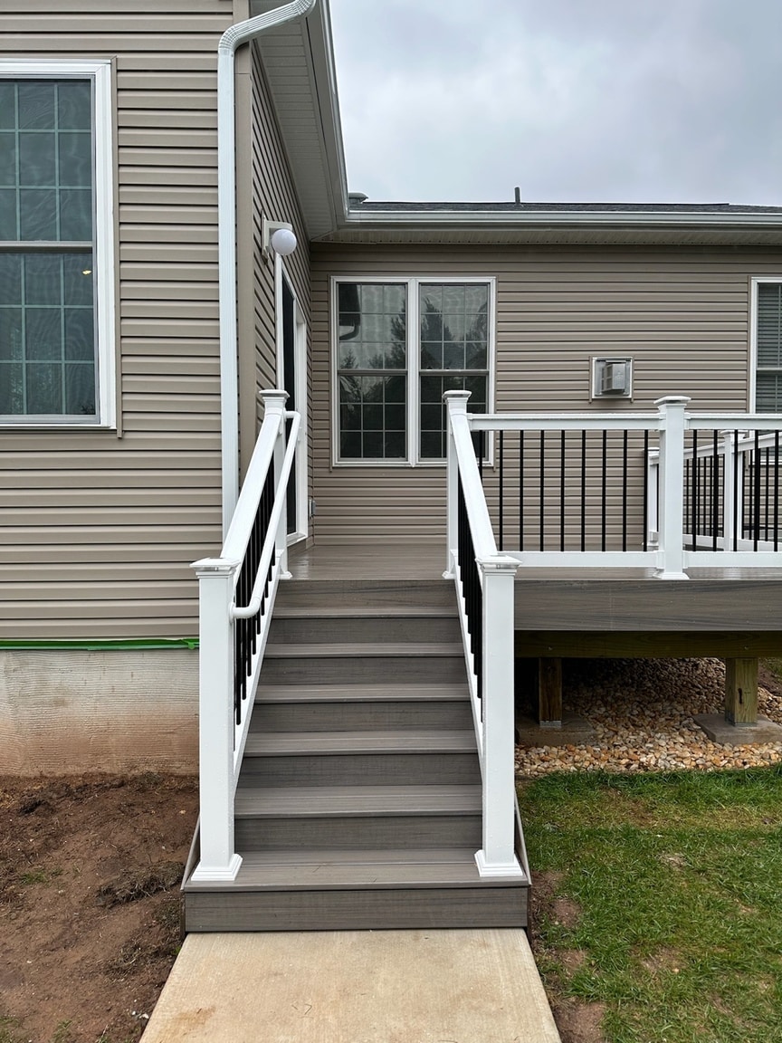Trex deck stair handrail with white posts and black balusters in Phoenixville Pennsylvania